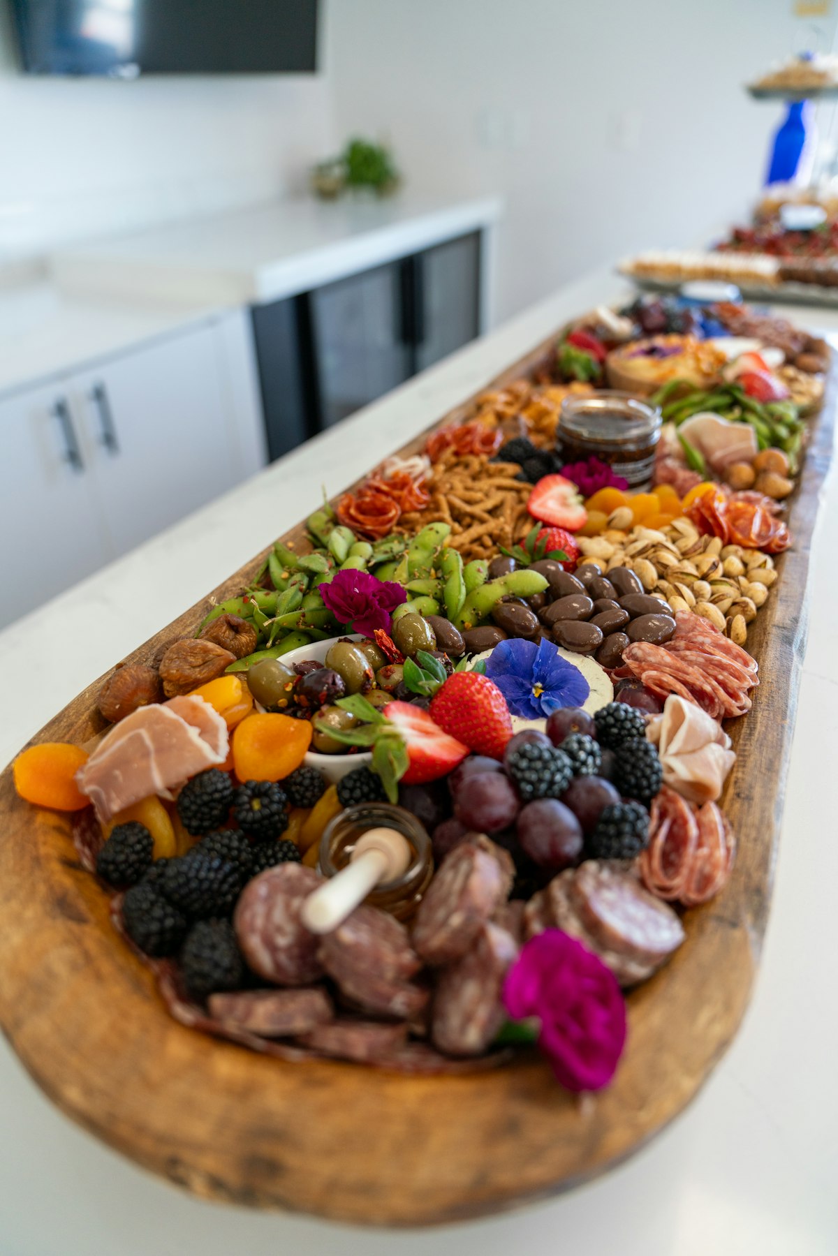 Catering spread — wraps, salads, sandwiches, fruit, and desserts