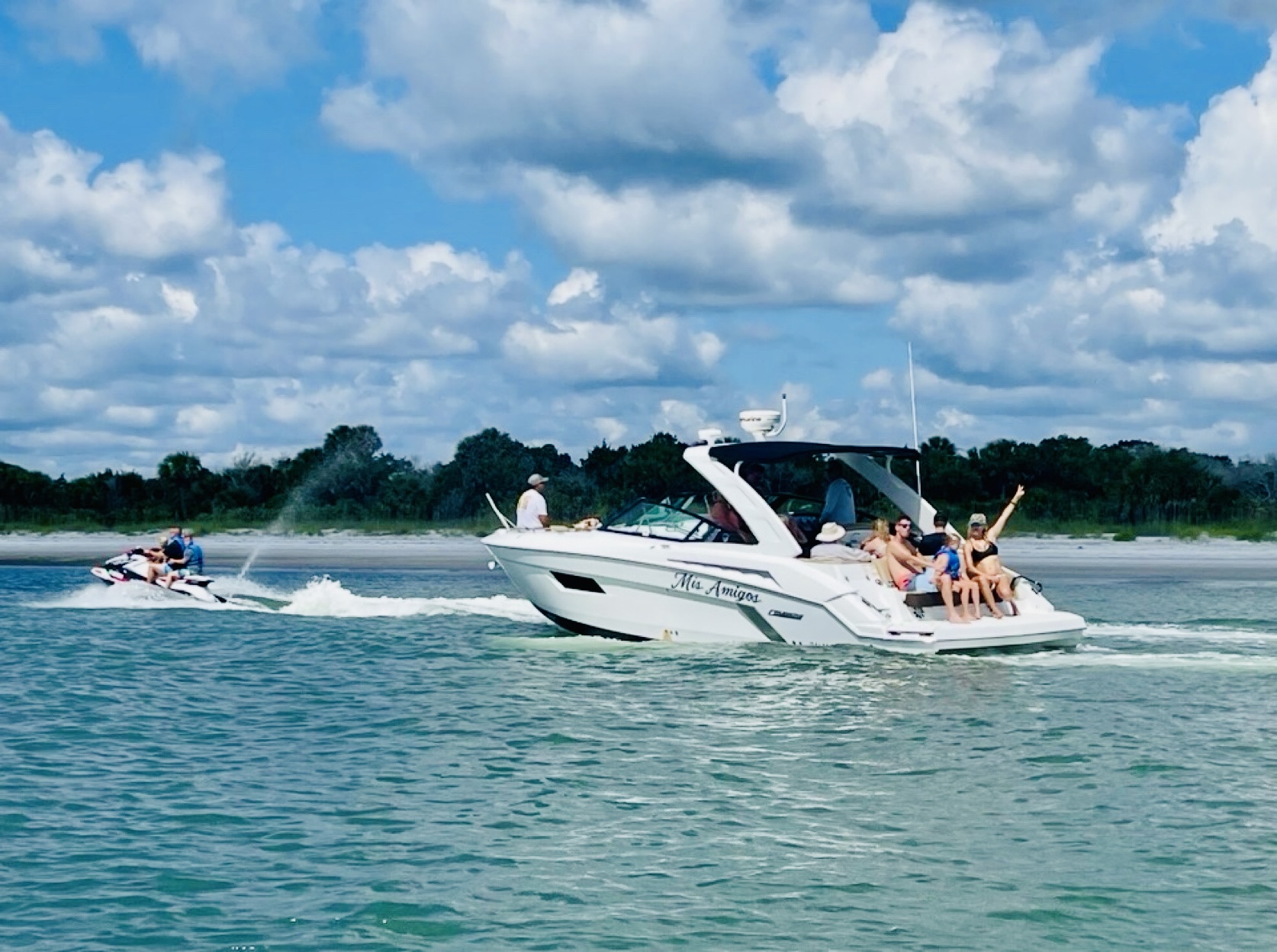 Mis Amigos yacht with jet ski in turquoise coastal waters — ocean adventure charter