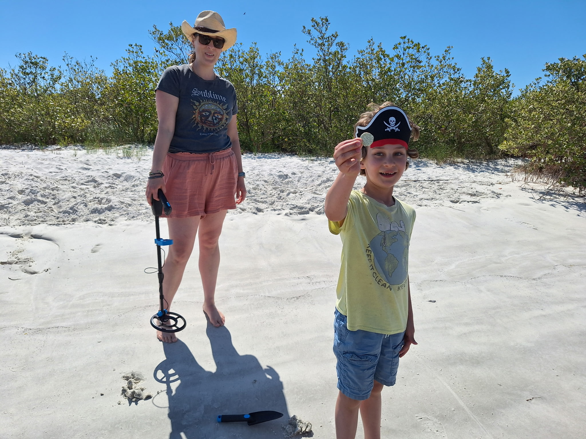 Treasure hunting on the Matanzas sandbar — kid in pirate hat with metal detector
